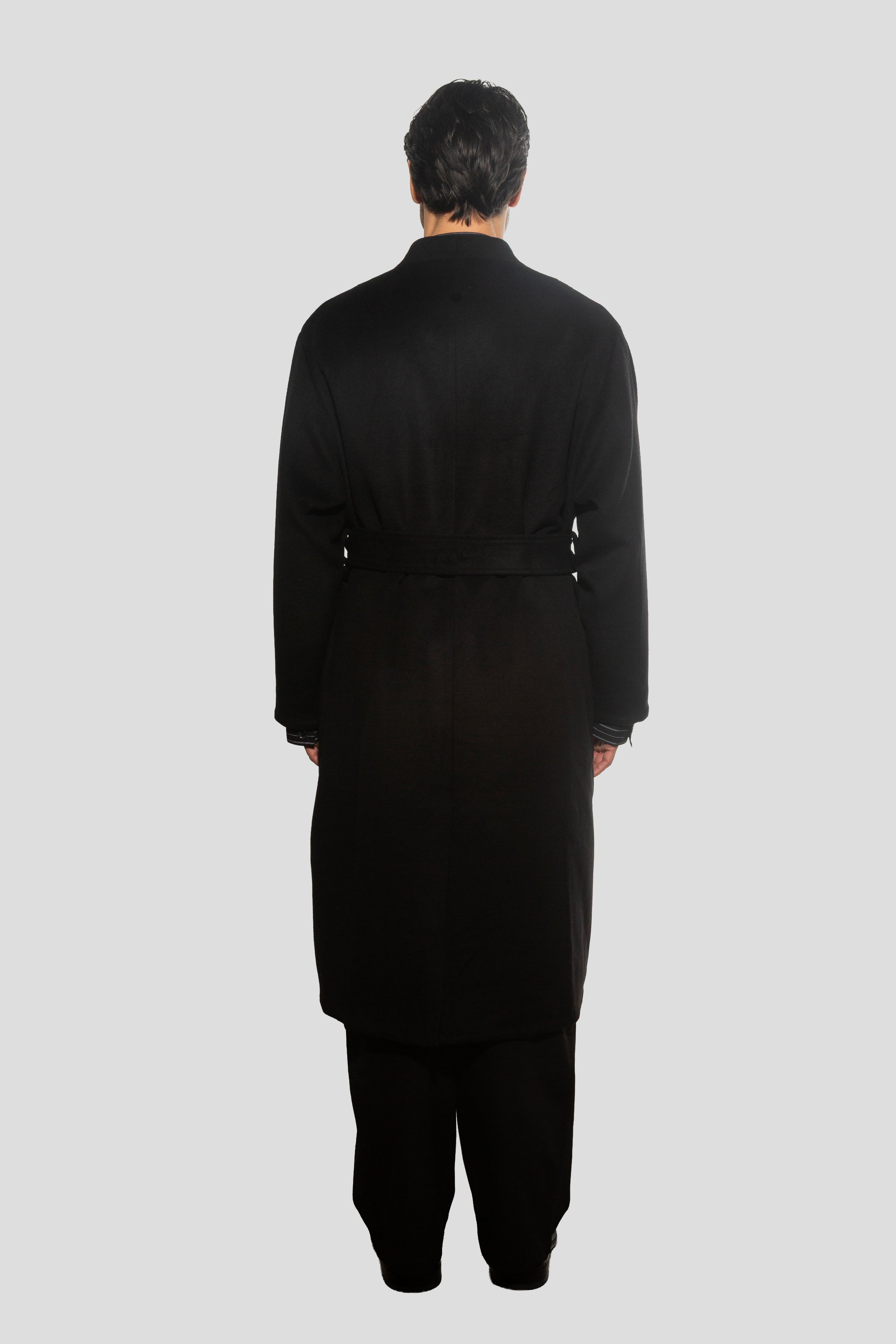 Person wearing a black outfit on a white background